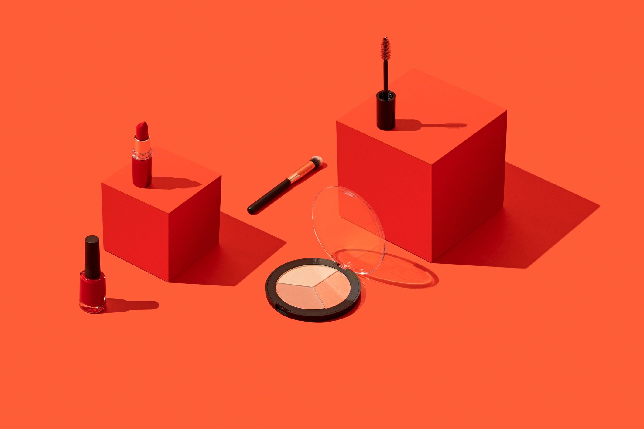 Editorial makeup products on a geometric background