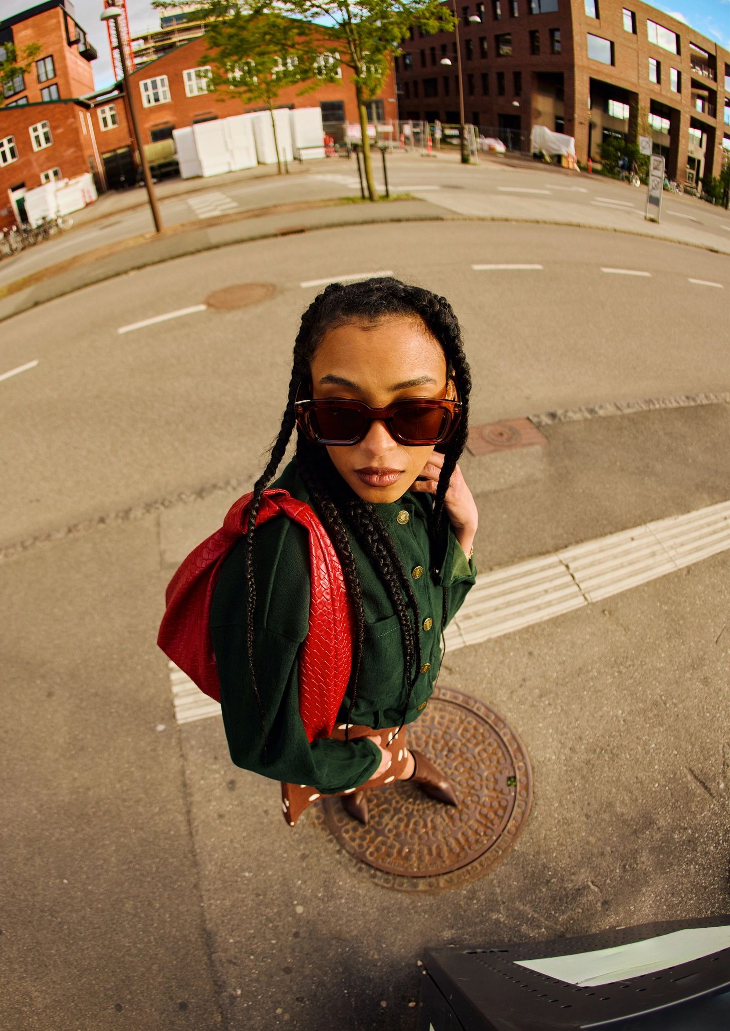 Fashionable young woman walking in city street